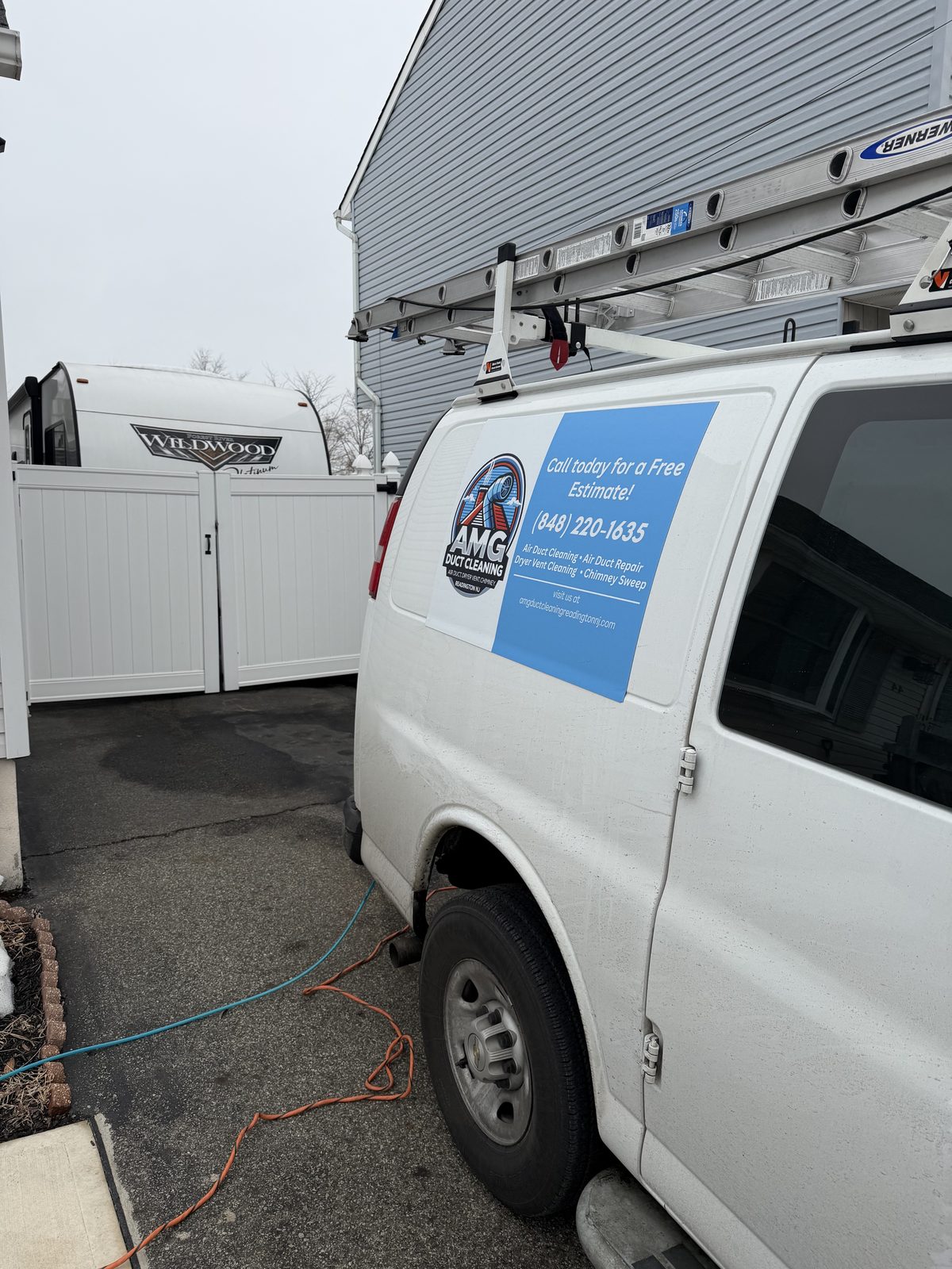 An AMG Duct Cleaning service van with the Readington phone number and website on its side
