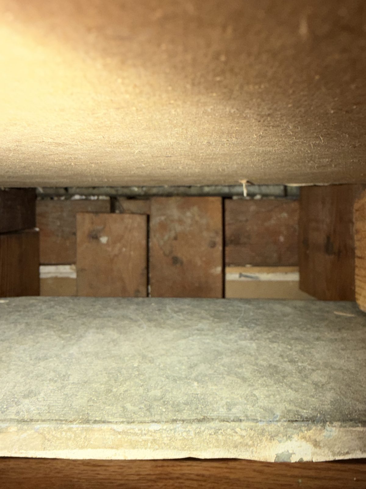 The same duct after cleaning, the wood and the panel beneath it clear