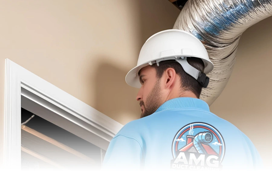 HVAC technician wearing a hard hat and uniform, inspecting air duct installation in Hudson, NJ.